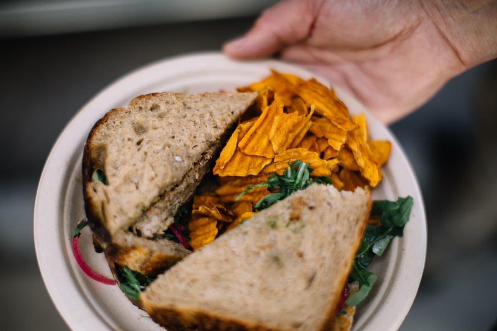 The Lambwich: a grass-fed lamb patty on toasted sourdough with pesto, arugula, and pickled onions.