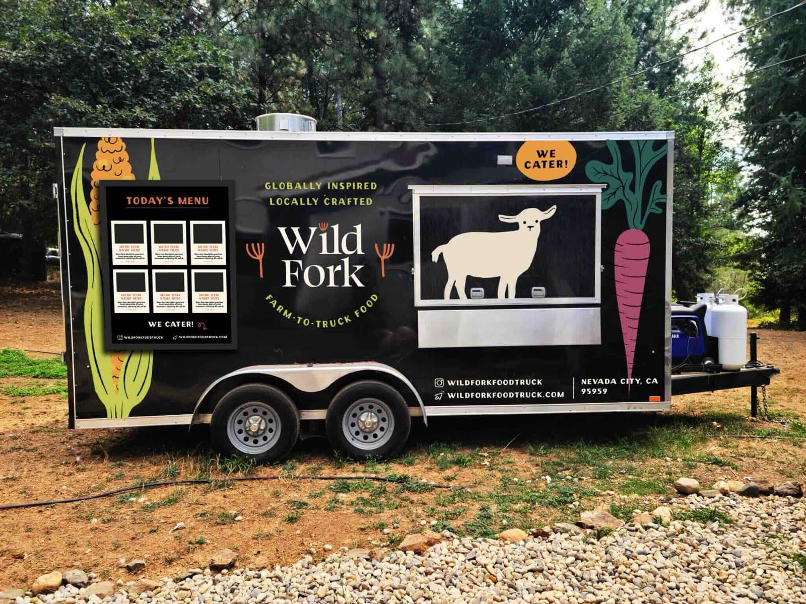 The Wild Fork trailer parked in a wooded clearing.